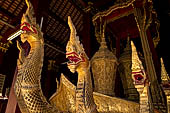 Wat Xieng Thong temple in Luang Prabang, Laos. Detail of flame-like gilded lacquered carvings of sacred serpents or nagas on the Royal Funerary Chariot. 